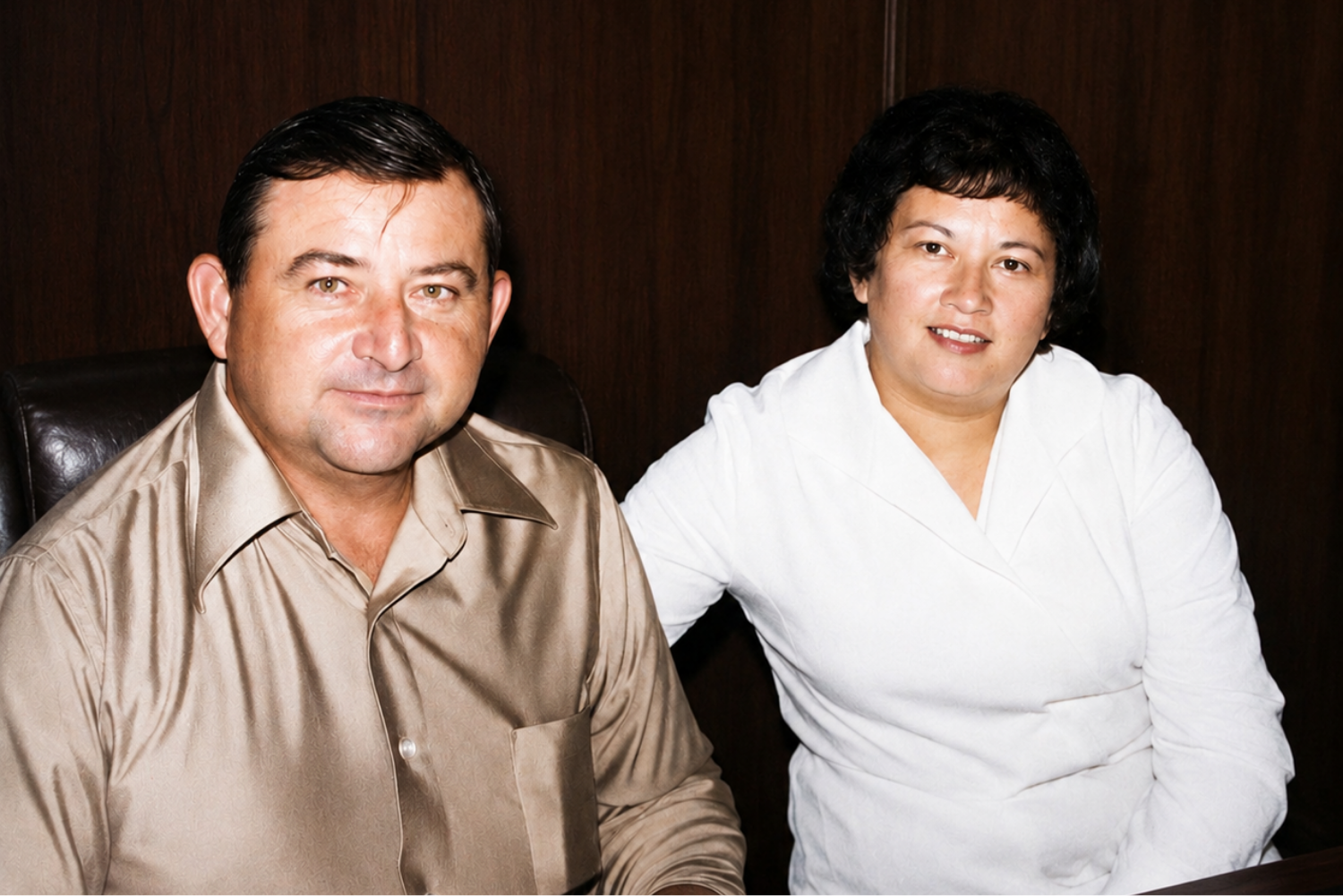 Clay and Marjorie pose for a photo sitting side-by-side indoors.