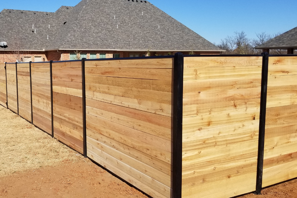 Horizontal cedar privacy fencing in residential neighborhood.