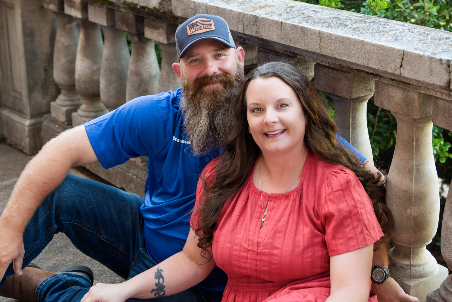 Steven and Jessica Yones sitting and posing in an outdoor setting.